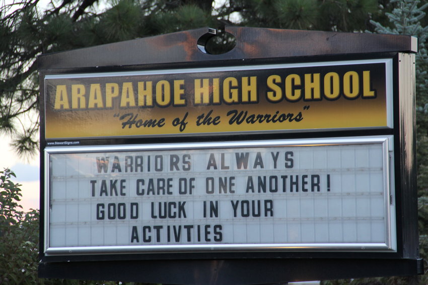 The sign at Arapahoe High School in Centennial reads, “Warriors always take care of one another! Good luck in your activities,” on Oct. 4. Two Arapahoe students died by suicide within just days of each other, the school announced in letters to parents.